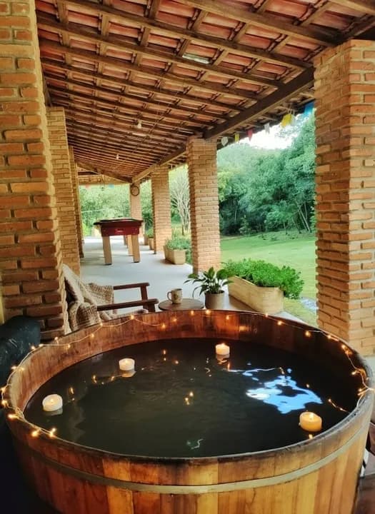 ofurô de madeira com velas na varanda
