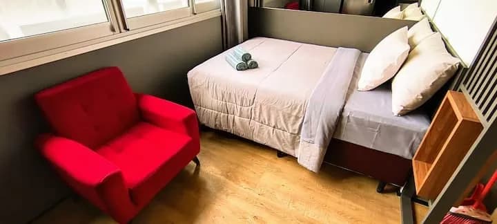 poltrona vermelha ao lado da cama